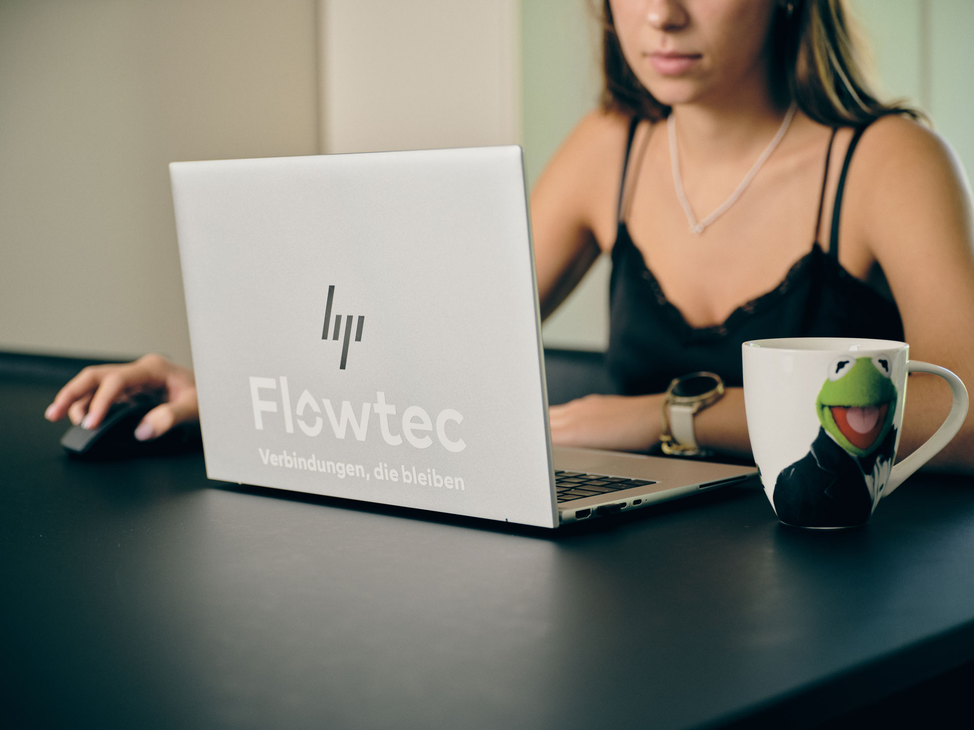 Flowtec-Mitarbeiterin beim mobilen Arbeiten am Laptop im Homeoffice